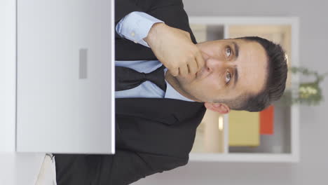 Vertical-video-of-Home-office-worker-man-thinking-depressed.
